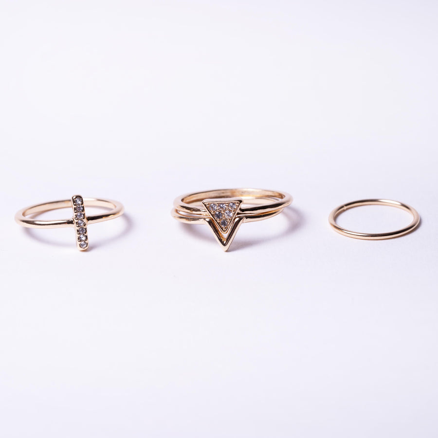 Gold crystal pave ring pack with midi ring, pave triangle interlink stack ring, stick ring and plain mini ring, jewellery layout